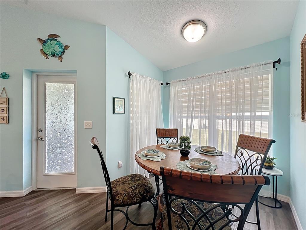 4501 East Ravenna Street Inverness, FL 34453 - Photo 6 of 31 a view of a dining room with furniture window and wooden floor