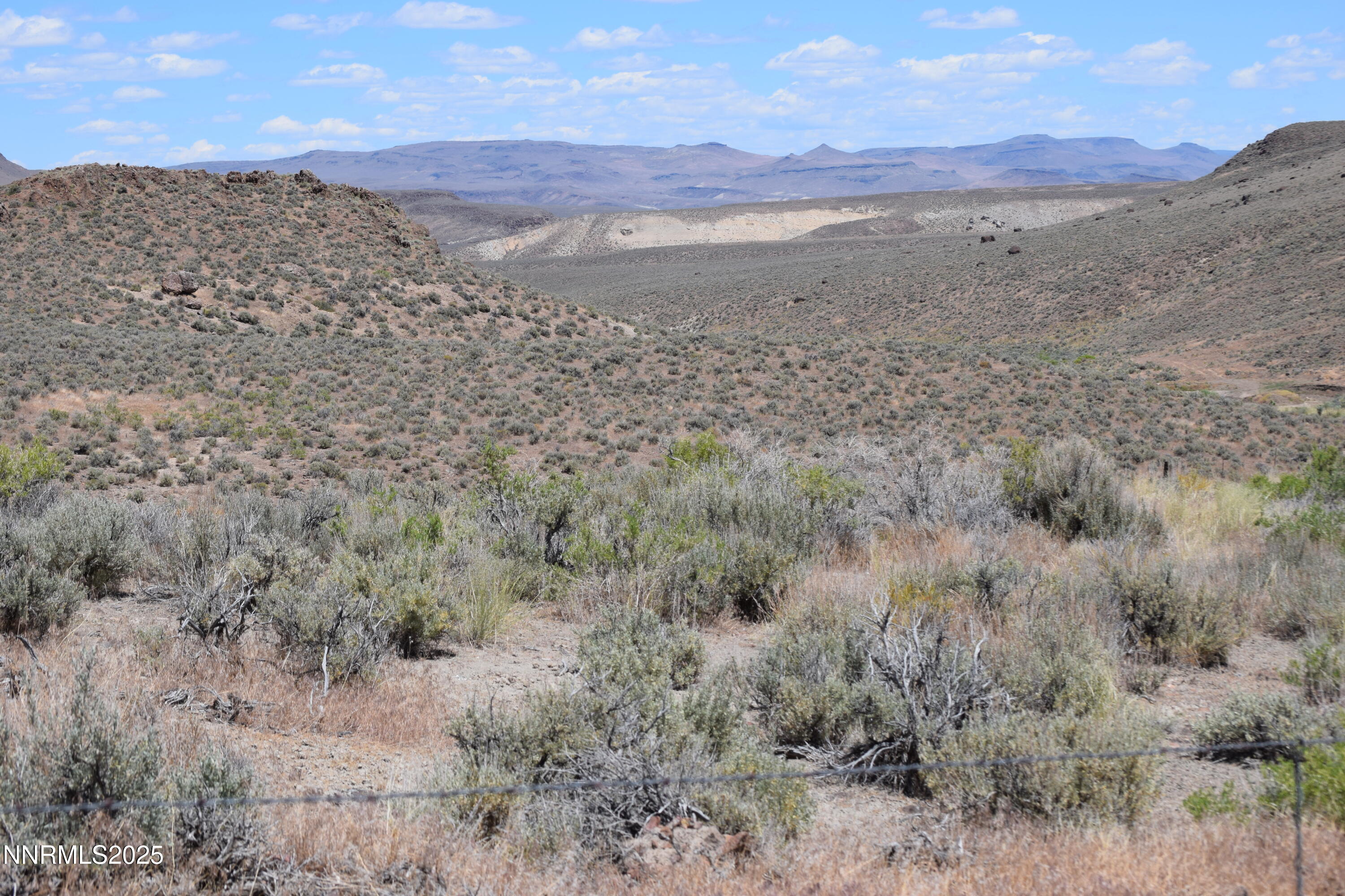 3305 High Rock Road Reno, NV 89510 - Photo 13 of 36 a view of a dry field with mountains in the background