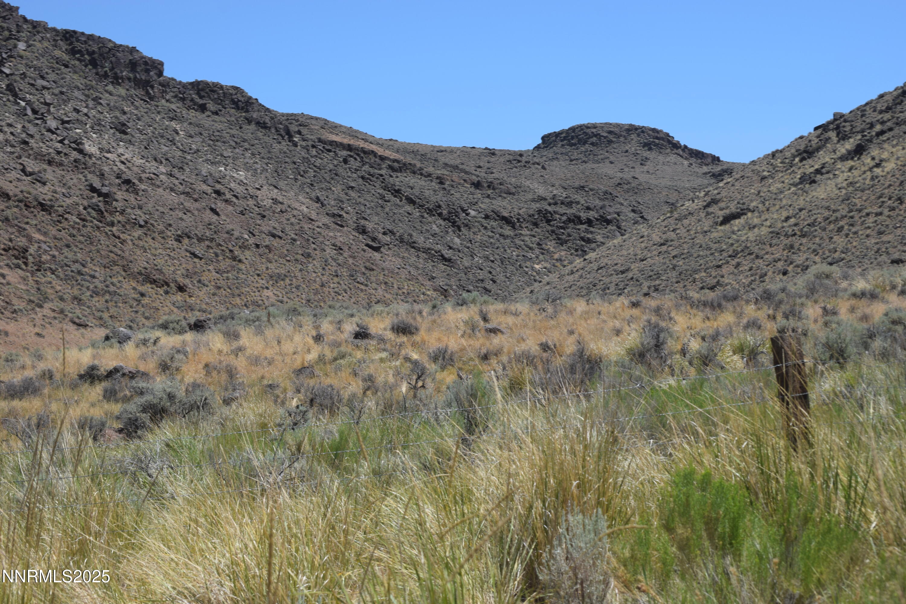 3305 High Rock Road Reno, NV 89510 - Photo 31 of 36 a view of a dry yard with mountains in the background