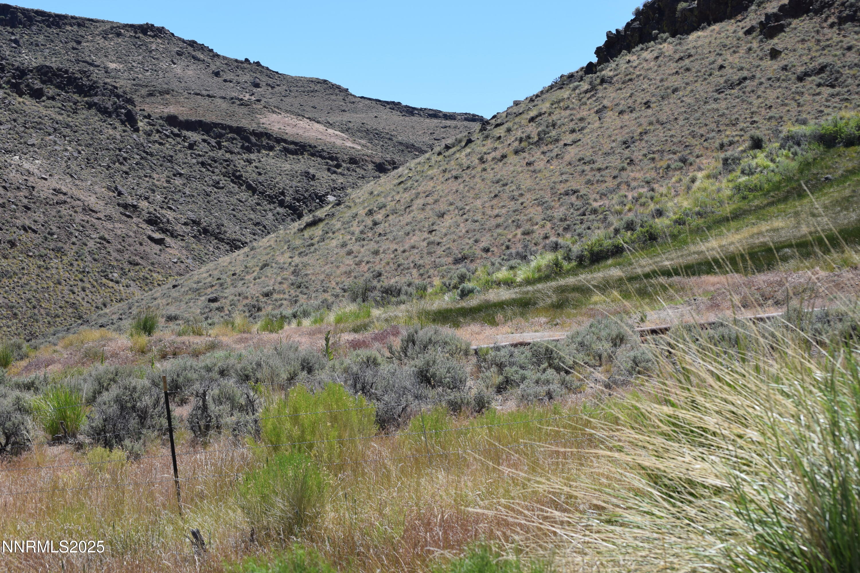 3305 High Rock Road Reno, NV 89510 - Photo 9 of 36 a view of a yard with a wooden fence