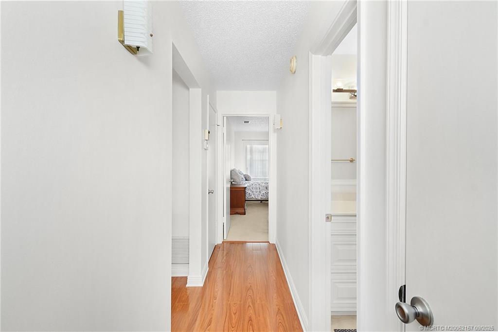 2600 Southeast Ocean Boulevard, Unit H15 Stuart, FL 34996 - Photo 15 of 27 a view of a hallway with wooden floor and staircase