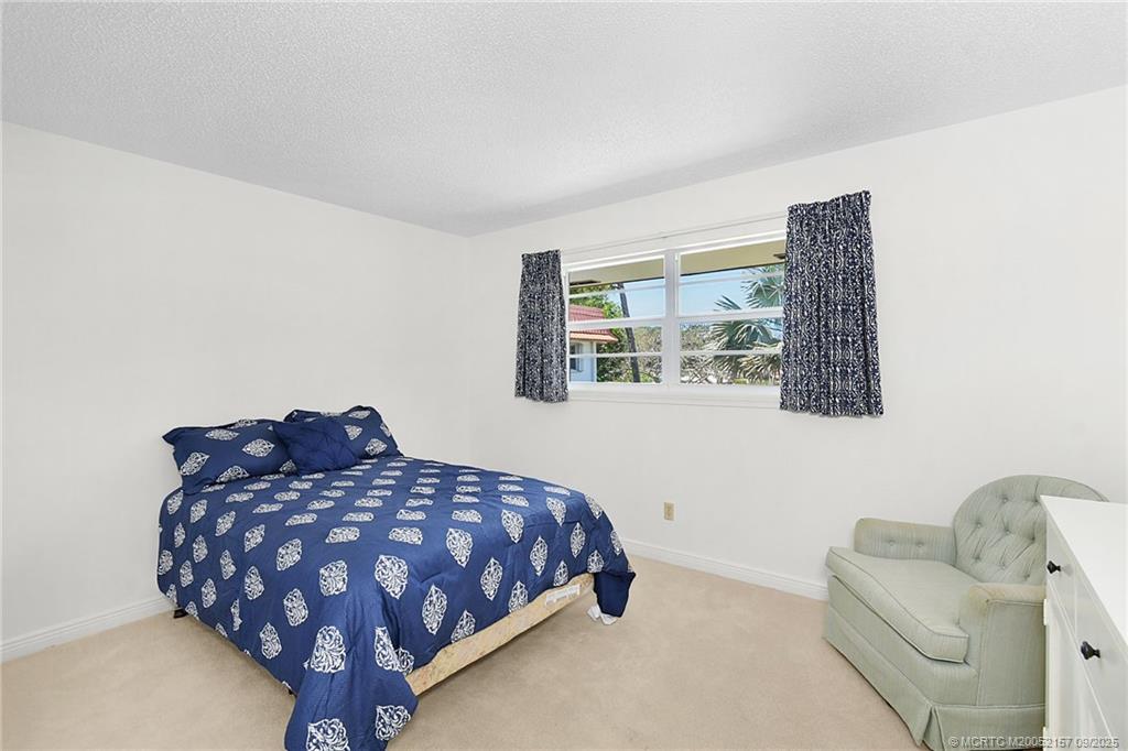 2600 Southeast Ocean Boulevard, Unit H15 Stuart, FL 34996 - Photo 16 of 27 a bedroom with a bed and window