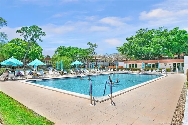 a view of a swimming pool with a lounge chair