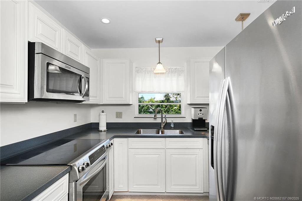2600 Southeast Ocean Boulevard, Unit H15 Stuart, FL 34996 - Photo 6 of 27 a kitchen with granite countertop a refrigerator and a sink