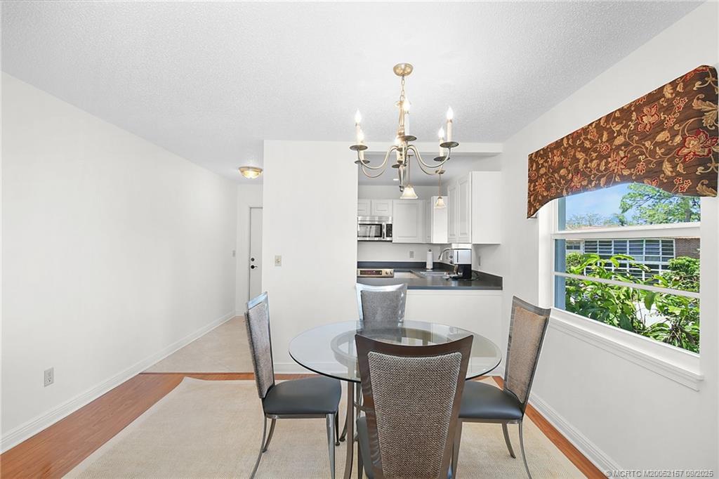 2600 Southeast Ocean Boulevard, Unit H15 Stuart, FL 34996 - Photo 8 of 27 a view of a dining room with furniture a rug and wooden floor