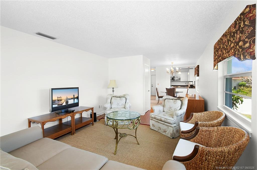 2600 Southeast Ocean Boulevard, Unit H15 Stuart, FL 34996 - Photo 10 of 27 a living room with furniture and a large window