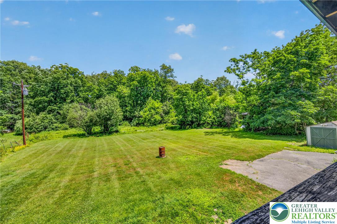 2674 Williams Road Danielsville, PA 18038 - Photo 6 of 31 A verdant, open lot bordered by mature trees offers ample space for outdoor enjoyment and expansion.