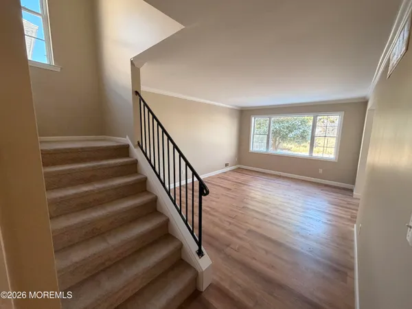 wooden floor in an empty room with a window