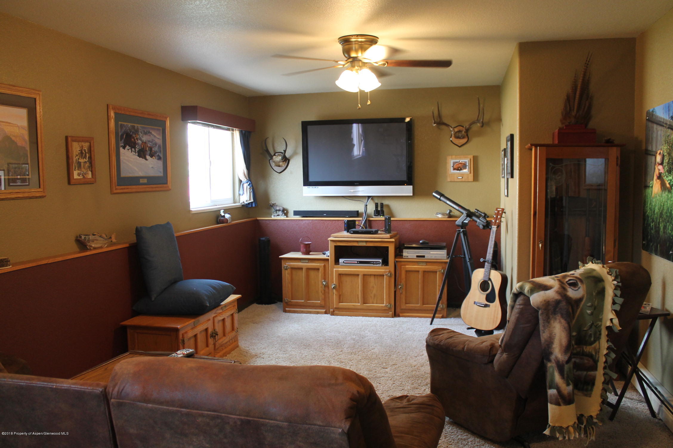 1561 East 12th Street Rifle, CO 81650 - Photo 20 of 23 a bedroom with furniture and a chandelier