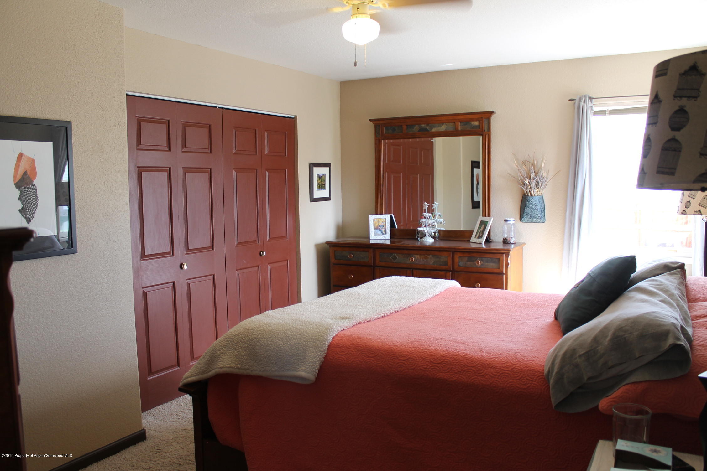 1561 East 12th Street Rifle, CO 81650 - Photo 8 of 23 a bedroom with a bed and a dresser in it