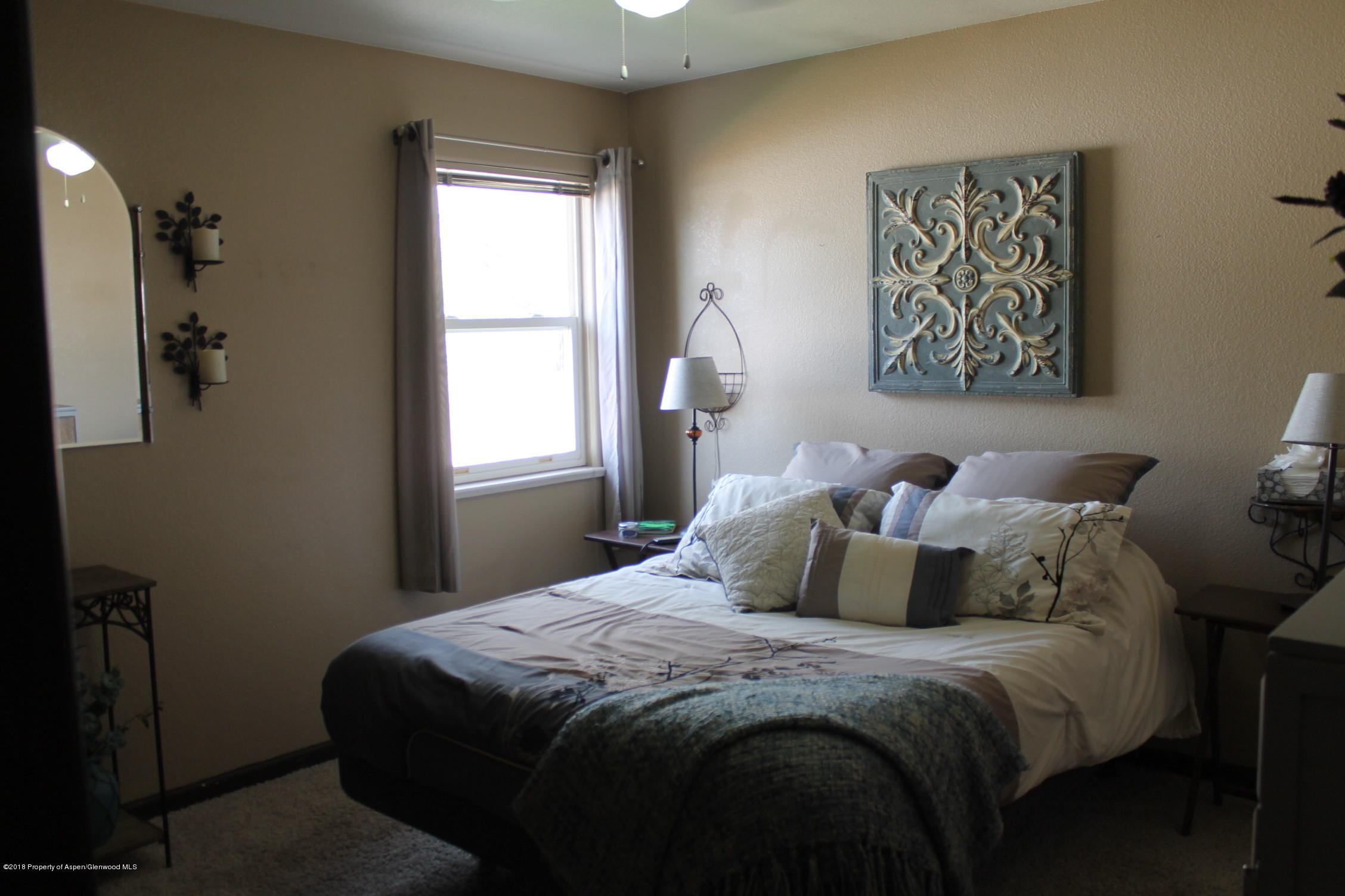 1561 East 12th Street Rifle, CO 81650 - Photo 10 of 23 a bedroom with a bed and a window