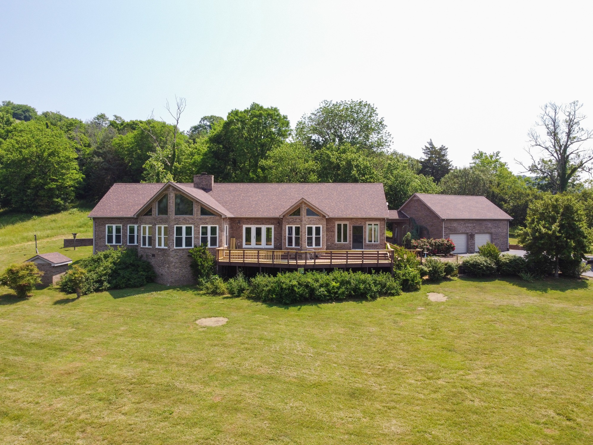 a front view of a house with yard and green space