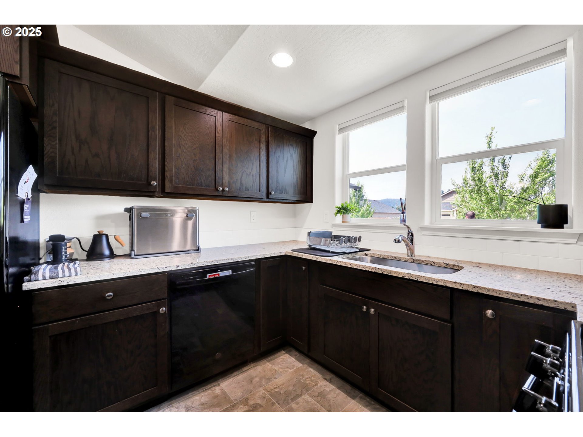 2057 South 59th Street Springfield, OR 97478 - Photo 12 of 28 a kitchen with a sink a window and cabinets