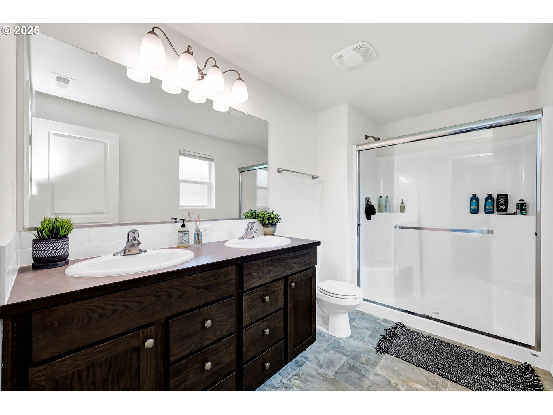 2057 South 59th Street Springfield, OR 97478 - Photo 17 of 28 a bathroom with a double vanity sink mirror and shower