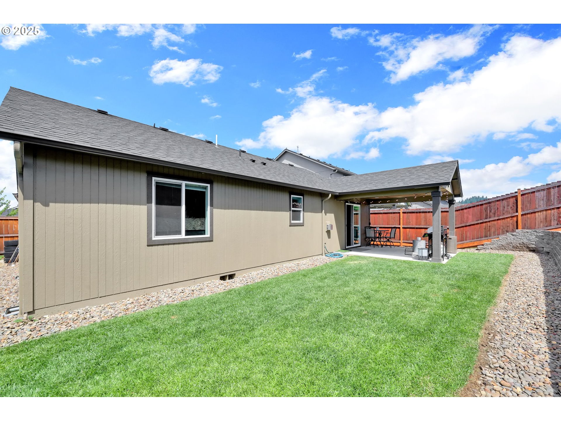 2057 South 59th Street Springfield, OR 97478 - Photo 23 of 28 a backyard of a house with table and chairs