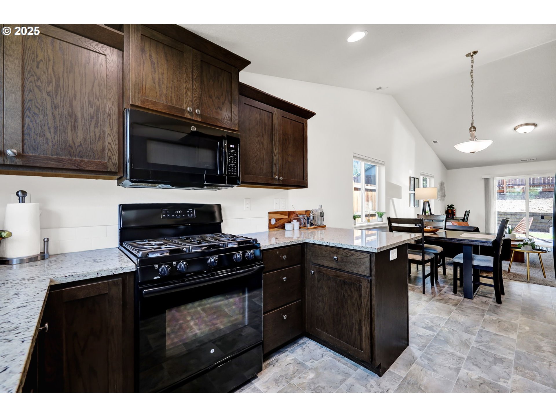 2057 South 59th Street Springfield, OR 97478 - Photo 9 of 28 a kitchen with a sink stove and microwave