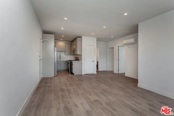 a view of a kitchen with a sink and a refrigerator