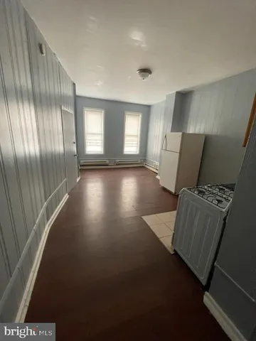 a kitchen with granite countertop a stove a sink and a microwave