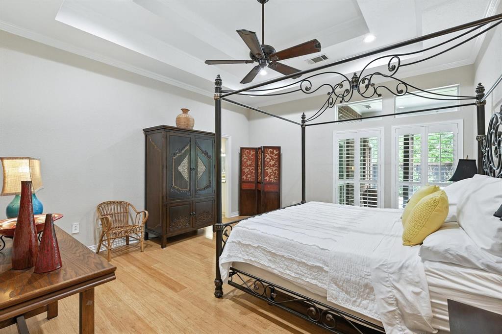 109 Visalia Lane Denton, TX 76210 - Photo 12 of 36 a bedroom with a bed next to a window with a chandelier