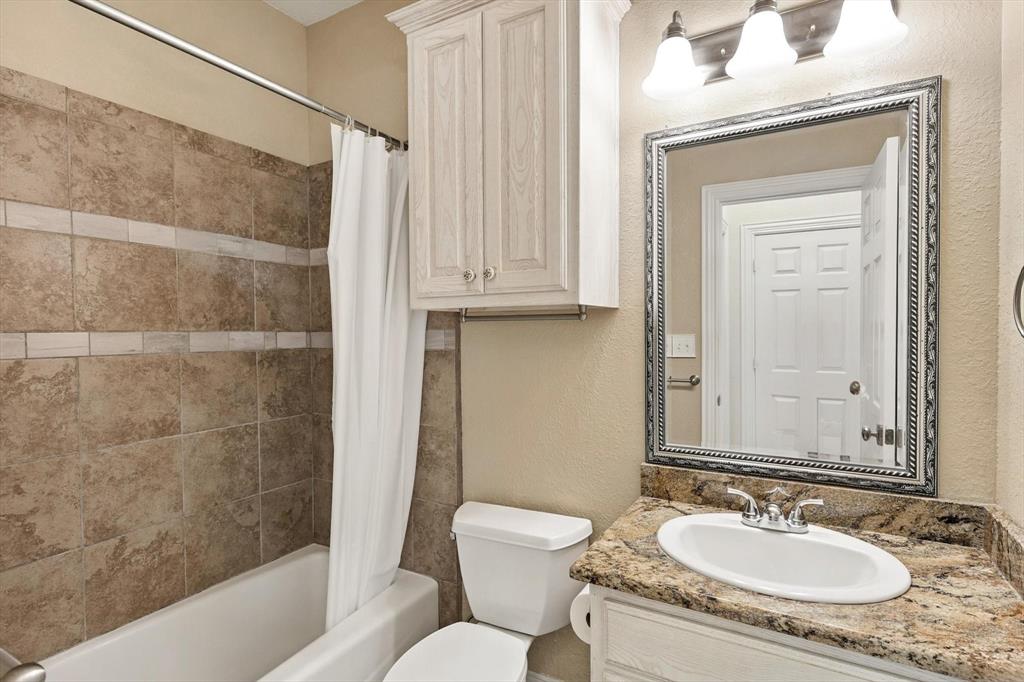 109 Visalia Lane Denton, TX 76210 - Photo 18 of 36 a bathroom with a granite countertop sink toilet and shower
