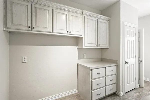 a kitchen with granite countertop white cabinets and sink
