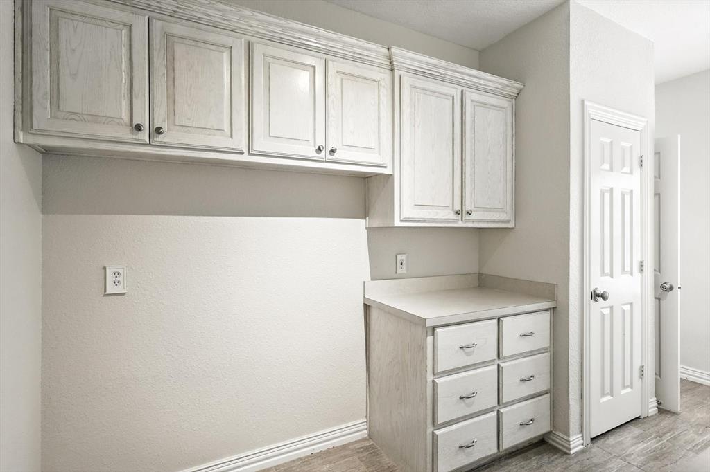 109 Visalia Lane Denton, TX 76210 - Photo 25 of 36 a kitchen with granite countertop white cabinets and sink