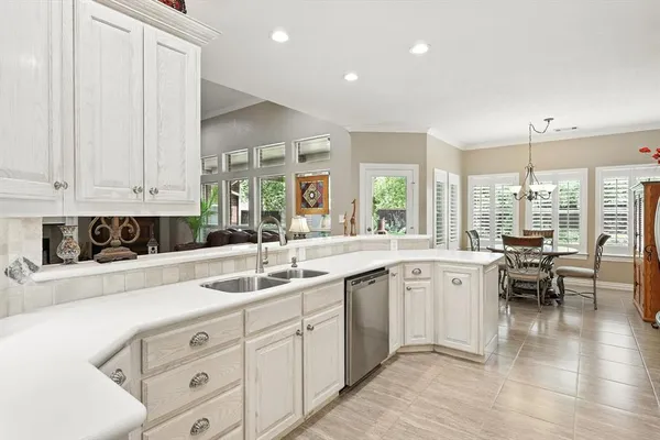 a kitchen with sink and cabinets