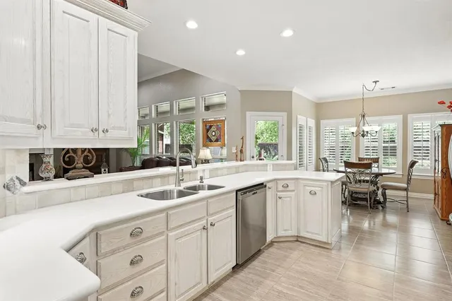 a kitchen with sink and cabinets