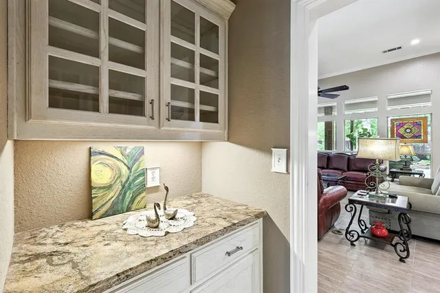 a kitchen with a granite countertop sink a stove and a wooden floors