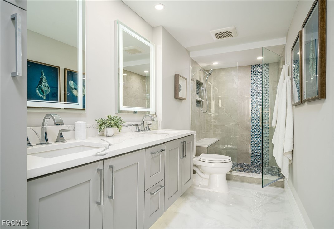 17 Bluebill Avenue, Unit 903 Naples, FL 34108 - Photo 15 of 33 a bathroom with a sink toilet and shower