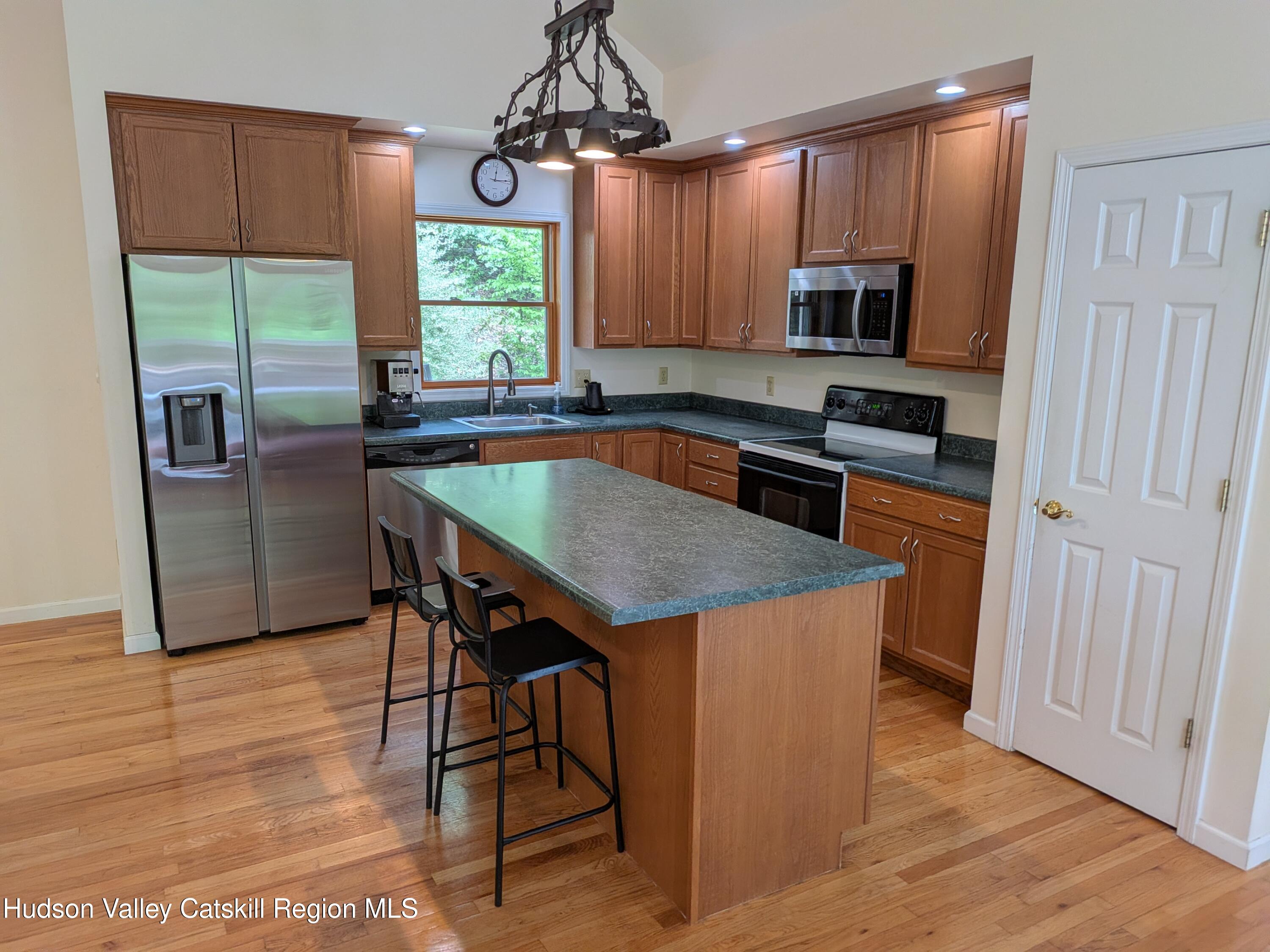 513 South Mountain Road Gardiner, NY 12525 - Photo 12 of 63 a kitchen with stainless steel appliances granite countertop a kitchen island hardwood floor sink and window