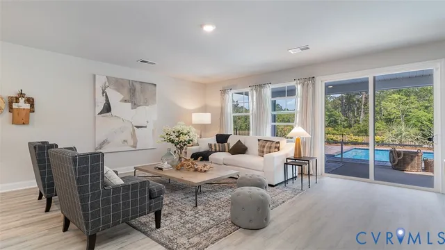 a living room with furniture and large windows