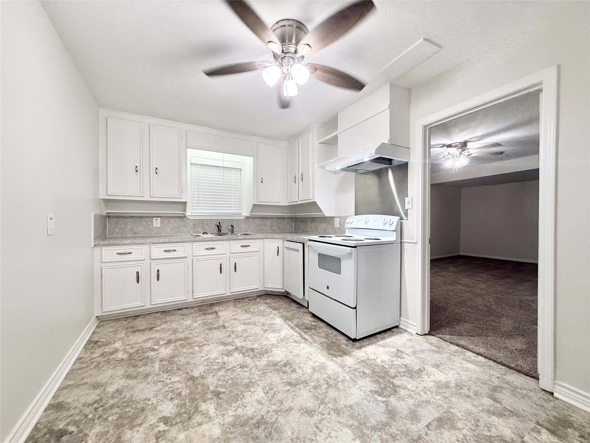 832 South Anderson Street Angleton, TX 77515 - Photo 9 of 19 a kitchen with granite countertop white cabinets and white appliances