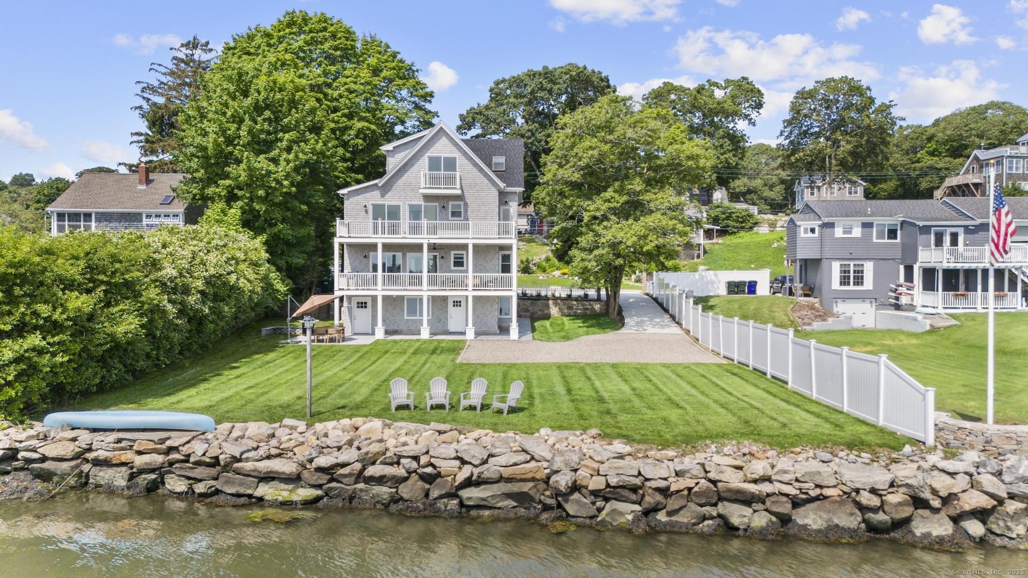a view of a house with a yard and sitting area