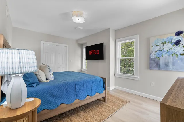 a bedroom with furniture and a window