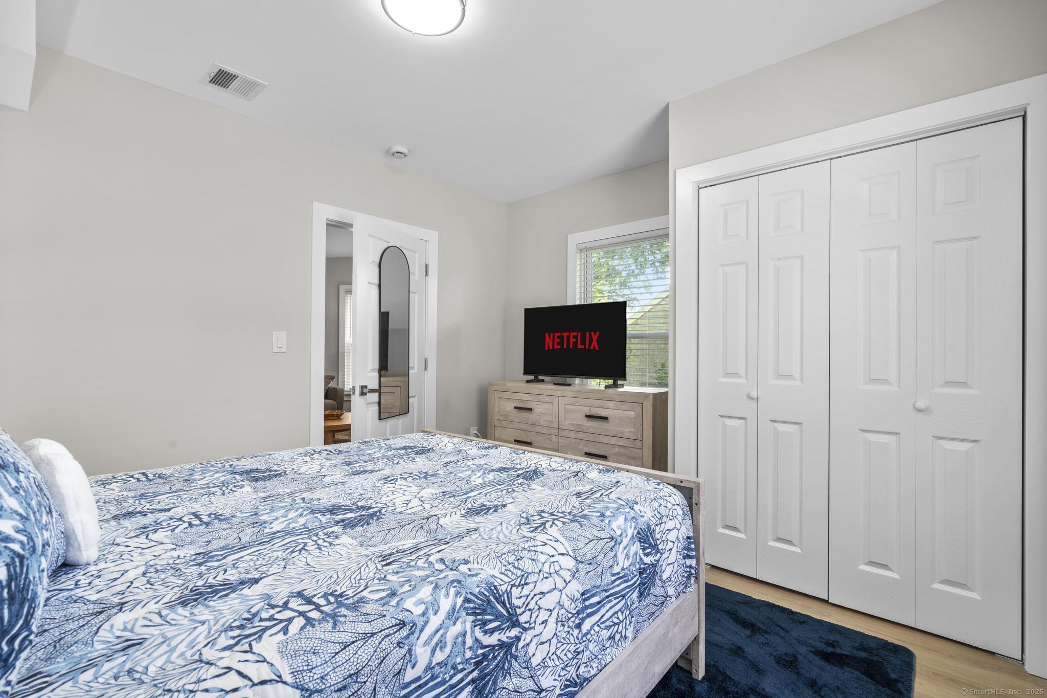 270 Elm Street, Unit 2 Groton, CT 06340 - Photo 14 of 36 a bedroom with a bed and a flat screen tv