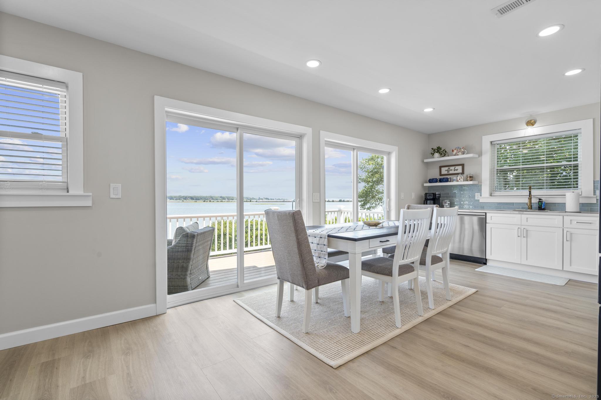 270 Elm Street, Unit 2 Groton, CT 06340 - Photo 16 of 36 a dining room with wooden floor a glass table and chairs