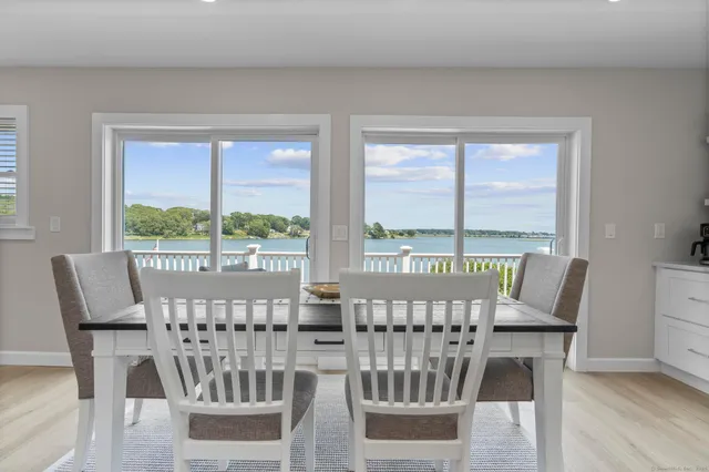 a view of a city from a dining room with furniture window and wooden floor