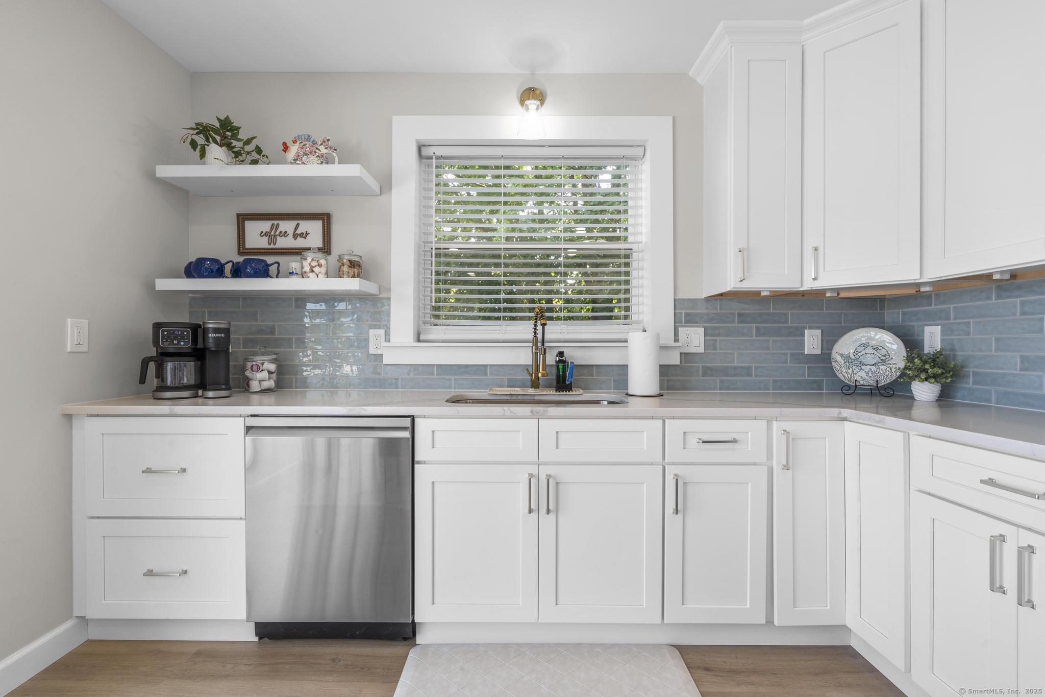 270 Elm Street, Unit 2 Groton, CT 06340 - Photo 19 of 36 a kitchen with white cabinets and window