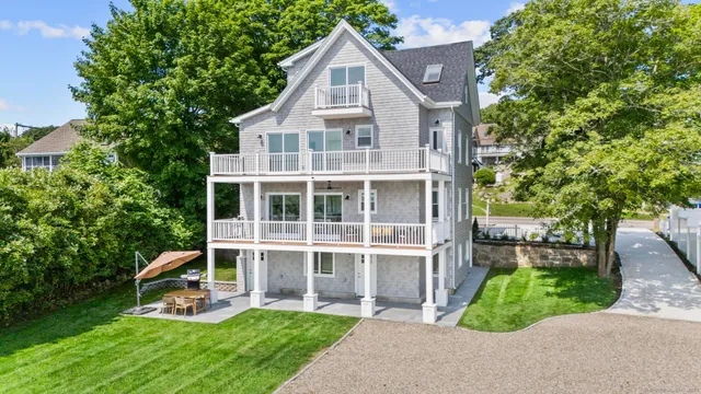 a view of a house with a yard and sitting area