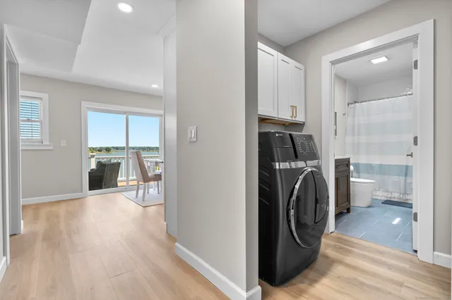 a bathroom with a sink a toilet and a large mirror