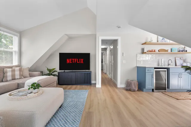 a living room with furniture and a potted plant