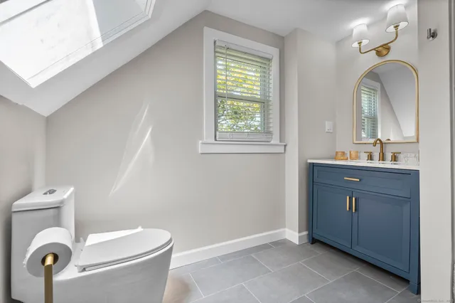 a bathroom with a tub shower vanity and a sink