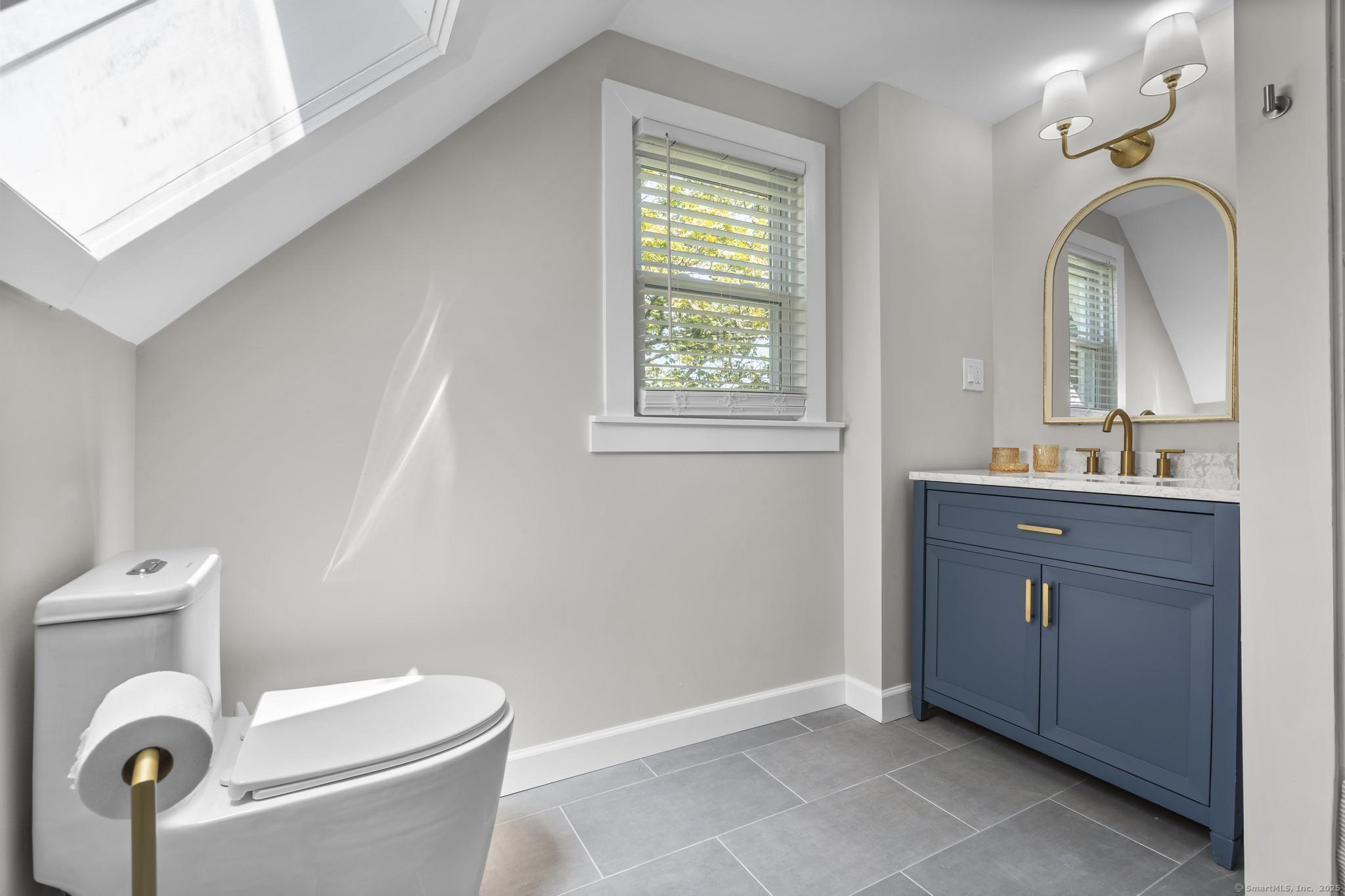 270 Elm Street, Unit 2 Groton, CT 06340 - Photo 31 of 36 a bathroom with a toilet sink and mirror