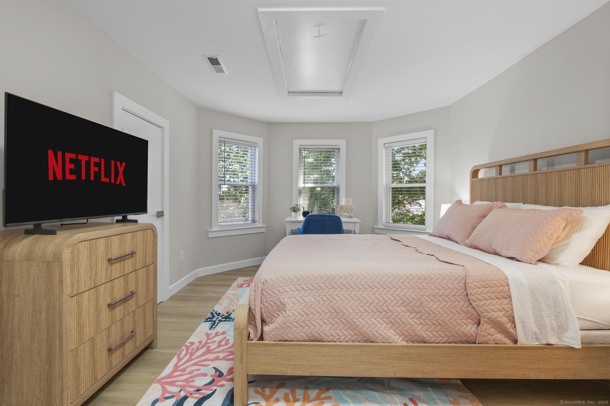 270 Elm Street, Unit 2 Groton, CT 06340 - Photo 33 of 36 a bedroom with a bed and a flat screen tv