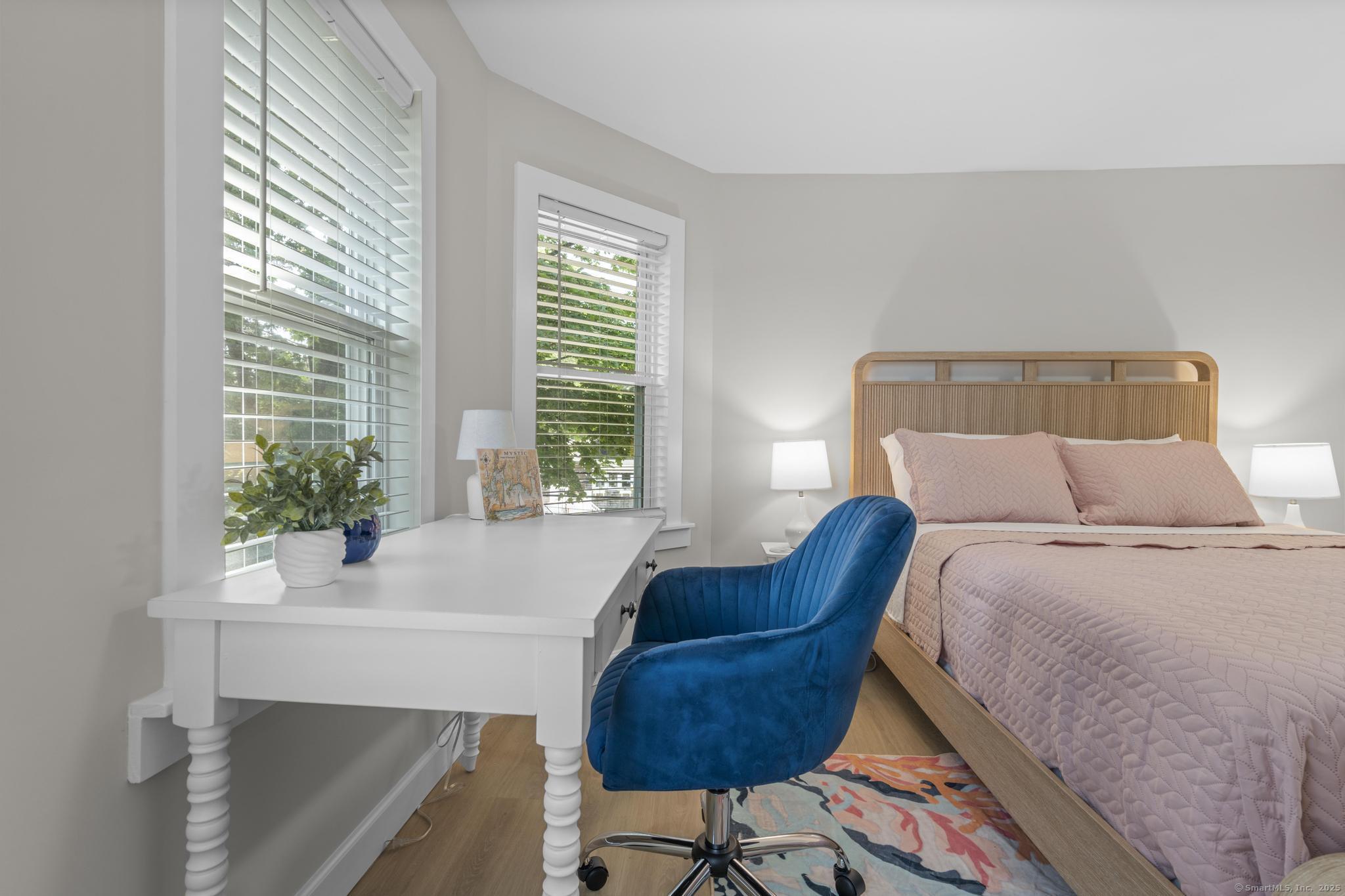 270 Elm Street, Unit 2 Groton, CT 06340 - Photo 34 of 36 a bed sitting in a bedroom next to a window and a chair