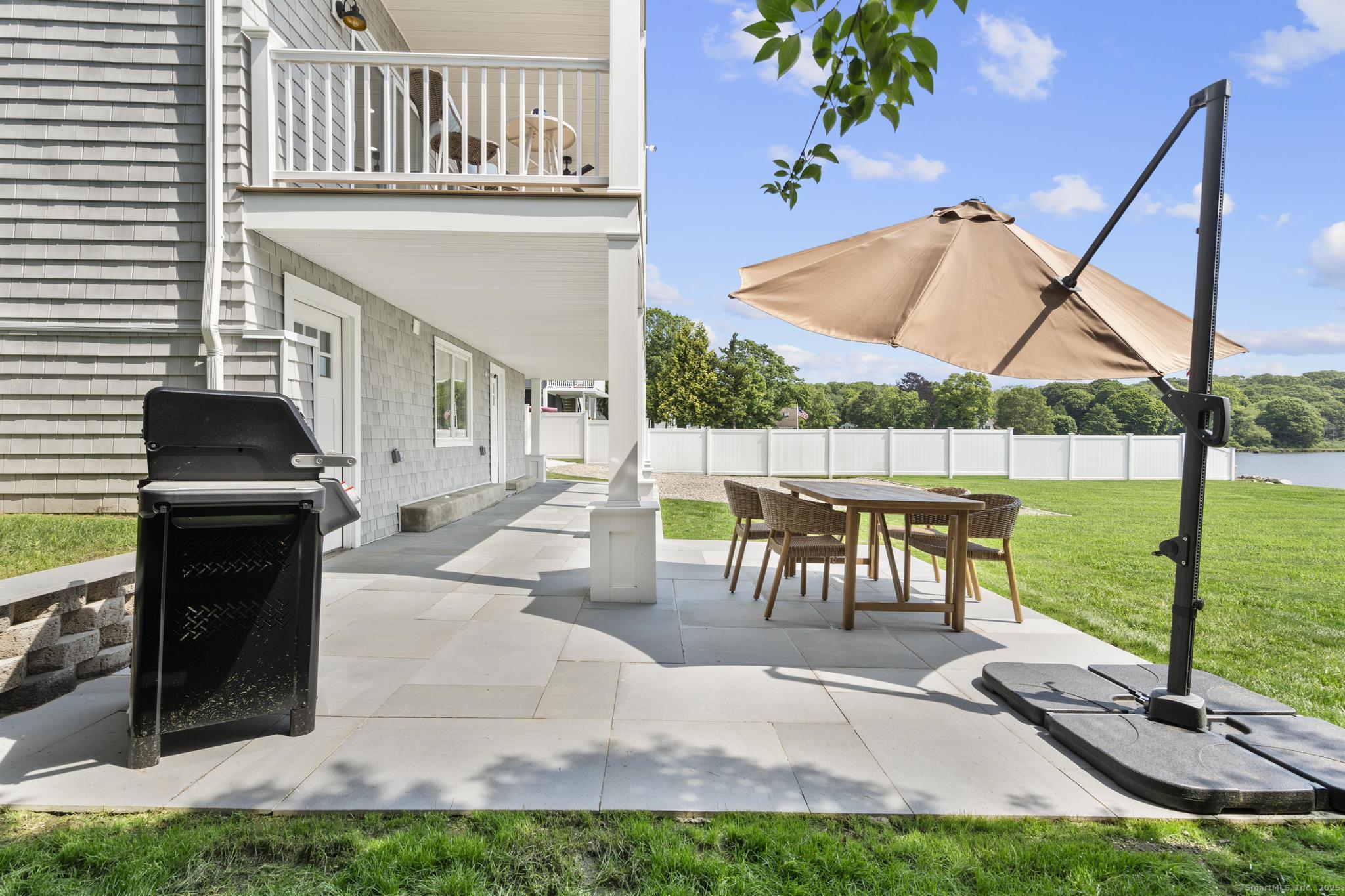 270 Elm Street, Unit 2 Groton, CT 06340 - Photo 4 of 36 a view of a patio with a table chairs and a garden