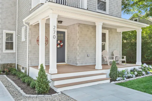 a front view of a house with a garden and plants