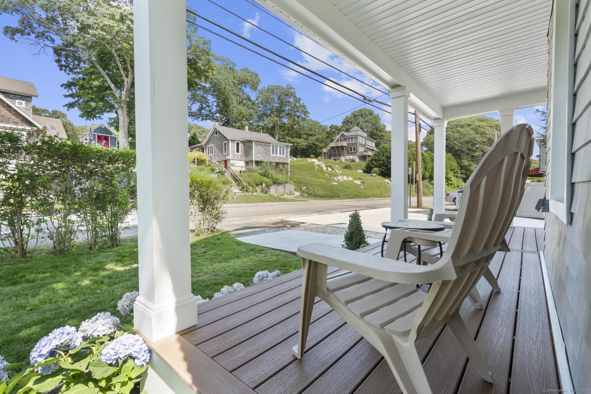 270 Elm Street, Unit 2 Groton, CT 06340 - Photo 8 of 36 a view of a patio with lawn chairs next to a yard