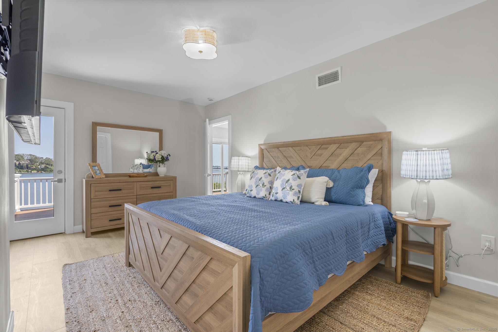 270 Elm Street, Unit 2 Groton, CT 06340 - Photo 10 of 36 a bedroom with a bed and a lamp on dresser